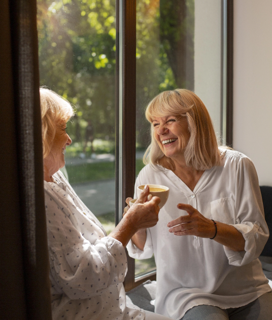 close-up-smiley-women-holding-cups